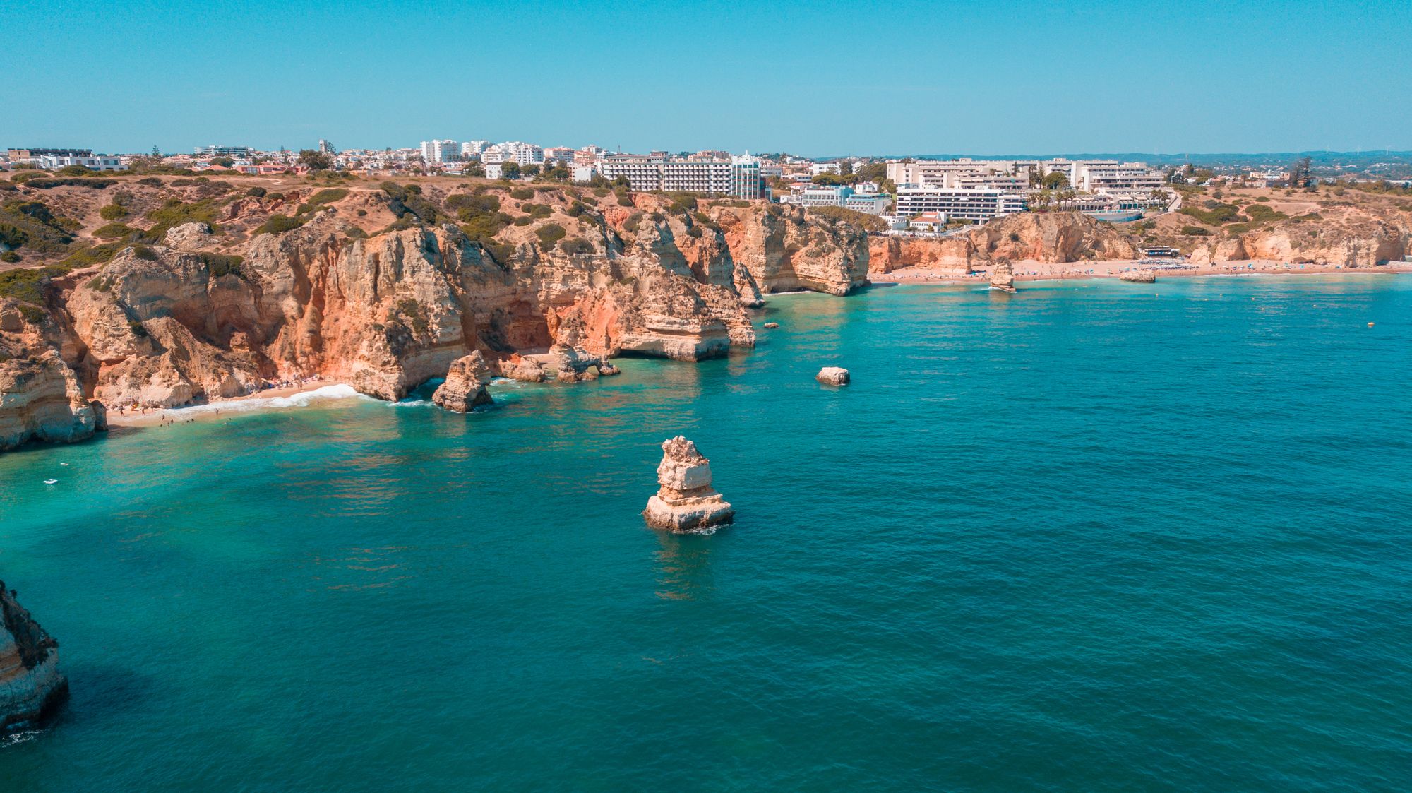 Golden cliffs and turquoise Atlantic water on Portugal’s Algarve coast